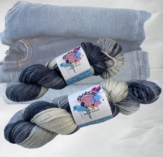 Hand dyed superwash Merino and bamboo DK weight yarn. Pooling jeans blue with grey and white fade.