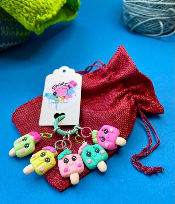 Five stitch markers with icecream decorations.