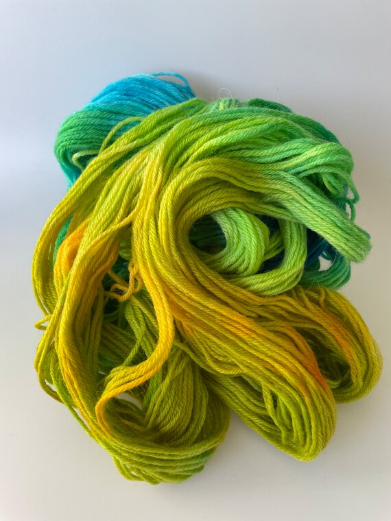 Hand dyed fine wool yarn in blue, yellow and green.