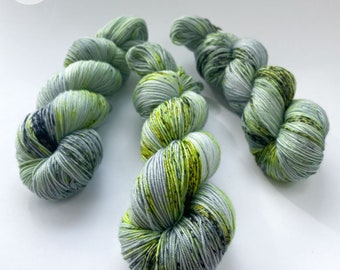 Hand dyed superwash Merino and Mulberry silk fingering weight yarn. ‘Madame Curie’. Grey base with fuorescent speckles.