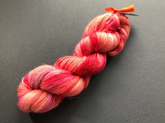 Hand dyed fine baby alpaca yarn in hot pink and warm red