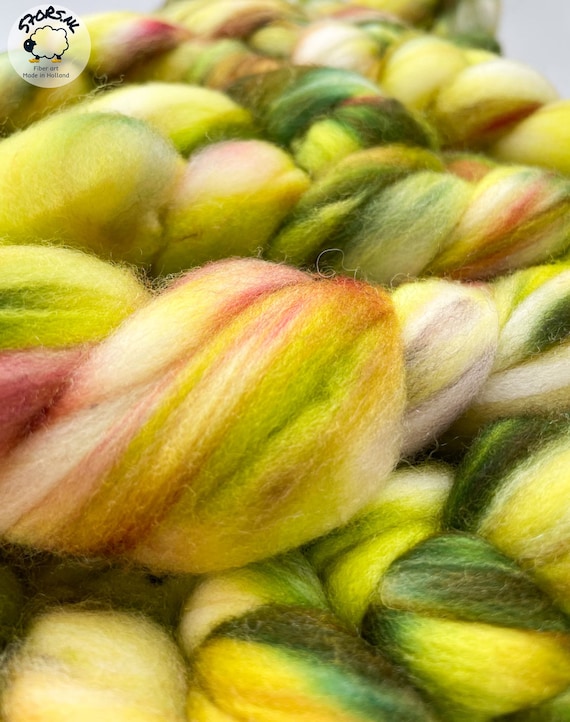 Hand dyed superwash extra fine Merino top. ‘Greens’. Specled dyed roving with fluoriscent accents.