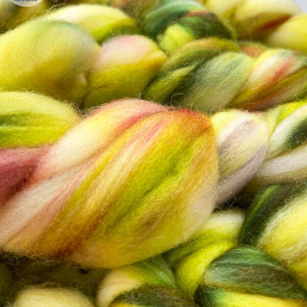 Hand dyed superwash extra fine Merino top. ‘Greens’. Specled dyed roving with fluoriscent accents.