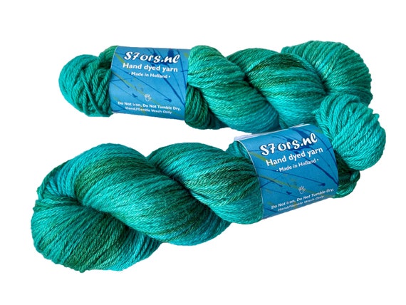 Hand dyed superwash Merino and mulberry silk Aran weight yarn. Ocean green.