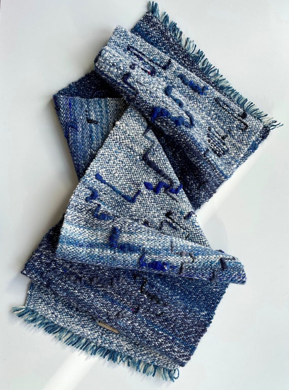Hand spun and hand woven scarf in blue and white. With lovely art yarn details and a hand dyed organic indigo warp.