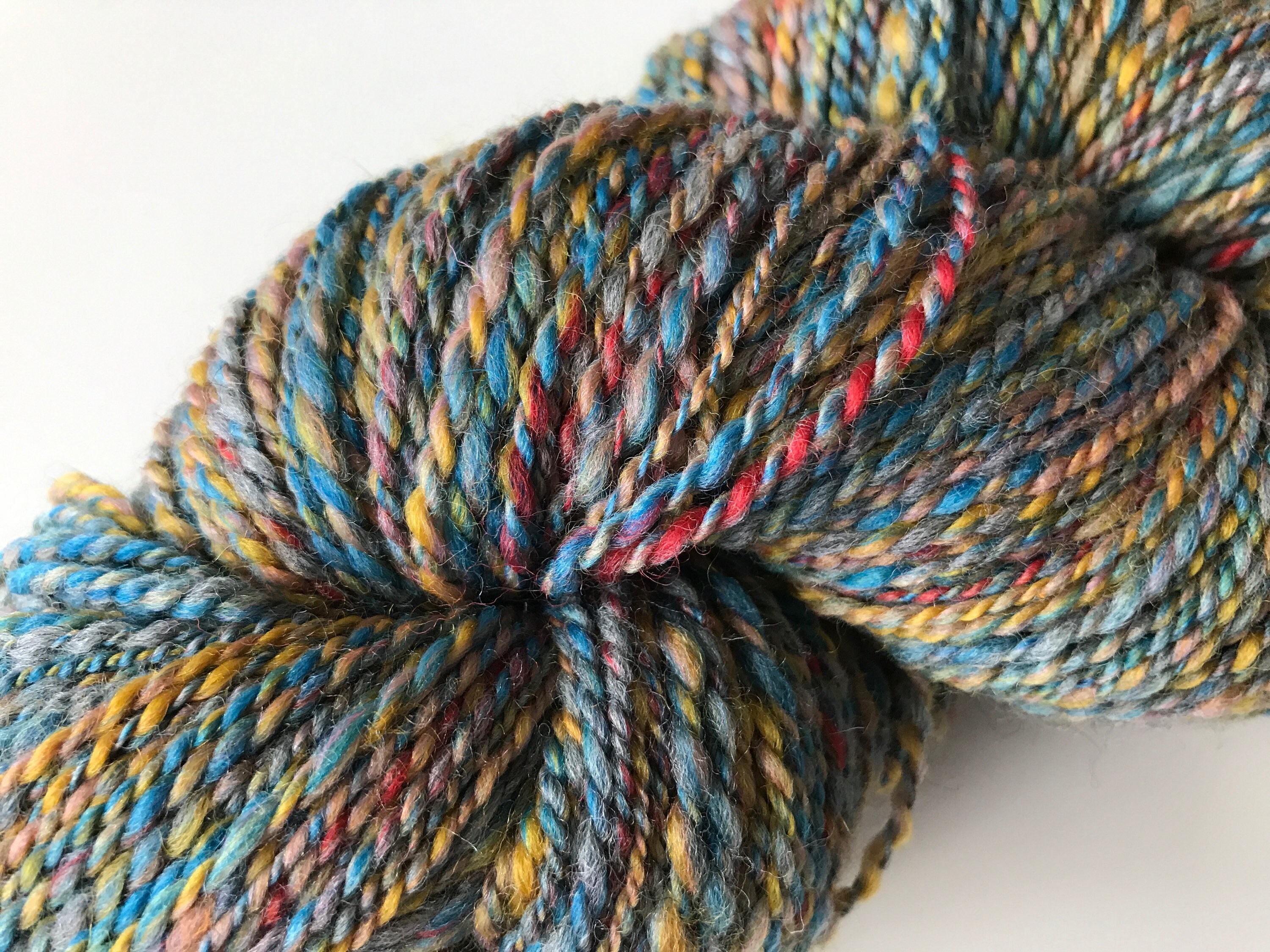 Sportweight hand spun yarn with BFL and Merino wool mix in blue, red