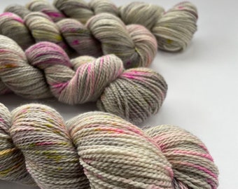 Hand dyed Superwash Merino, A Grade Mulberry Silk and Cashmere sock weight yarn. Platinum grey with pink an chartreuse speckles.