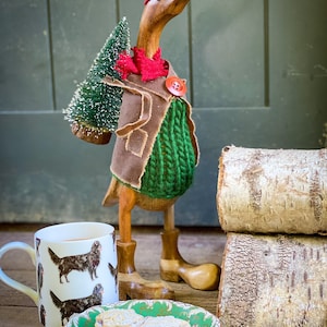 Papa (the Christmas tree carrying wooden duck) bamboo duck with boots, Christmas tree, wax jacket, tweed flat cap & scarf. Collect the tree.