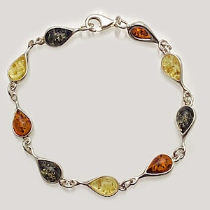 May include: A silver bracelet with a teardrop-shaped amber stones in shades of green, yellow, and orange.