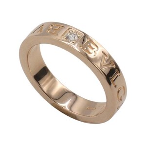 May include: A rose gold band ring with the word "BVLGARI" engraved around the band. A single diamond is set in the center of the band.