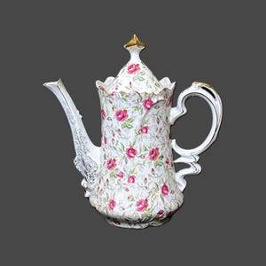 May include: A set of three ceramic mugs with a speckled, matte finish. Each mug features a different color: light blue, cream, and gray. The mugs have a simple, modern design with a rounded shape and a handle.