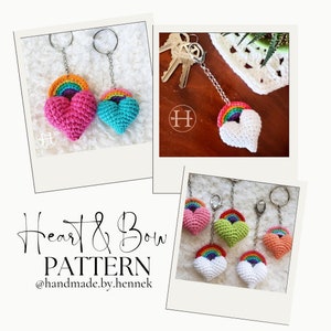 May include: Crochet heart and rainbow keychains in pink, blue, green, and white. The keychains are attached to silver key rings. The image includes the text "Heart & Bow PATTERN @handmade.by.hennek"