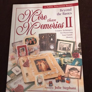 May include: A book titled "More than Memories II" with the subtitle "Creative Techniques for Preserving Your Family History." The cover features various framed photos and decorative elements, with the text "Edited by Julie Stephani."