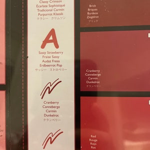 May include: A chart with different shades of red, labeled with names in English, French, Spanish, German, and Japanese. The names include: Classy Crimson, Sassy Strawberry, Cranberry, Red, Brick.