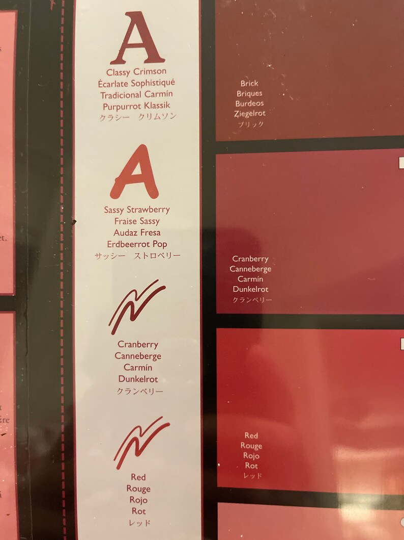 May include: A chart with different shades of red, labeled with names in English, French, Spanish, German, and Japanese. The names include: Classy Crimson, Sassy Strawberry, Cranberry, Red, Brick.
