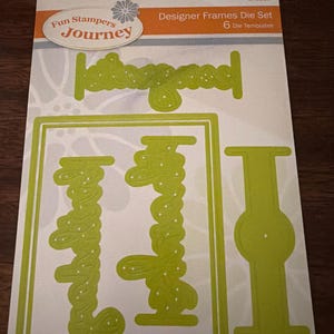 May include: A package of Designer Frames Die Set with six die templates. The package features the Fun Stampers Journey logo and the die templates are a bright green color. The die templates include the word "Journey" and a rectangular frame.
