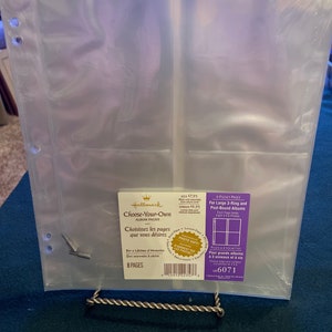 May include: Clear plastic photo album pages with 4 pockets per page. The package says "Choose-Your-Own Album Pages" and "For Large 3-Ring and Post-Bound Albums".