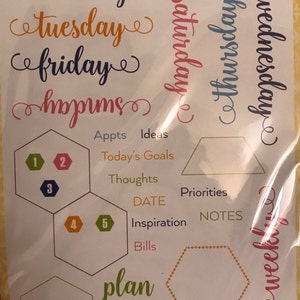 May include: Clear planner stamps with days of the week, hexagonal shapes, and words like "Ideas," "Today's Goals," and "Plan." The set includes 30 stamps, perfect for organizing a planner.