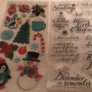 May include: Clear sheet of Christmas-themed stickers and stamps. Stickers include a penguin, snowman, ornaments, candy cane, and Christmas tree. Stamps feature holiday greetings such as "Merry Christmas" and "Happy New Year".