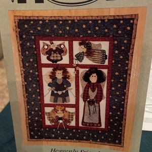 May include: A quilt pattern featuring five angels with stars and a red, white, and blue color scheme. The pattern is titled "Heavenly Friends" and is from Timid Thimble Creations.