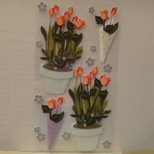 May include: A sheet of stickers featuring orange and red tulips in white pots and bouquets. The tulips have green leaves and are accented with small blue and yellow flower stickers. The pots have a light blue rim.