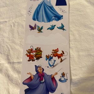 May include: A set of Cinderella-themed stickers featuring Cinderella in her blue ball gown, a clock, a castle, birds, mice, and the Fairy Godmother.
