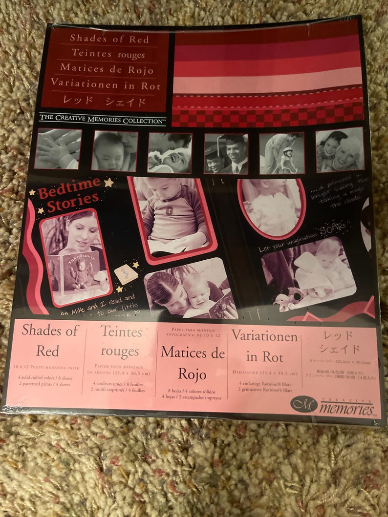 May include: A package of photo mounting paper titled "Shades of Red" with the text "Bedtime Stories." The package features a collage of baby photos and is from "The Creative Memories Collection."
