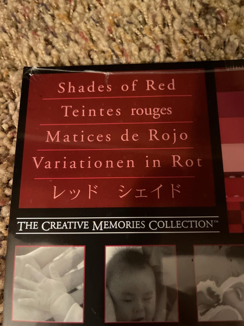 May include: A red-toned product box with the text "Shades of Red" in English, French, Spanish, German, and Japanese. The Creative Memories Collection logo is visible.