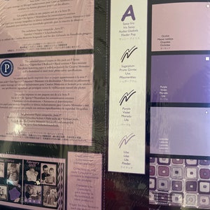 May include: A close-up of a colorful chart with color swatches and names in English, French, Spanish, and Japanese. The chart is for Creative Memories scrapbooking paper. The colors include purple, lavender, lilac, orchid, sugarplum, eggplant, and classy wine.
