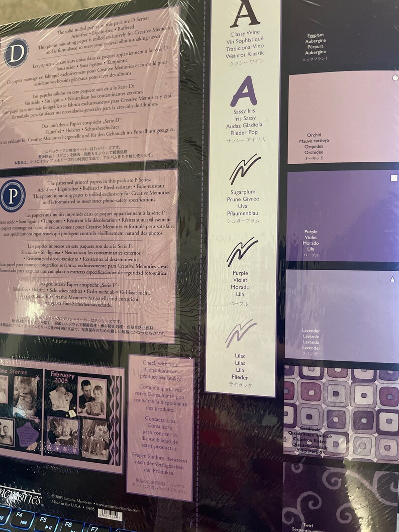 May include: A close-up of a colorful chart with color swatches and names in English, French, Spanish, and Japanese. The chart is for Creative Memories scrapbooking paper. The colors include purple, lavender, lilac, orchid, sugarplum, eggplant, and classy wine.