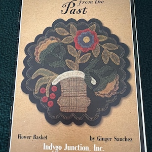 May include: A book cover with the title "Pennies from the Past" and a floral design. The design features a flower basket with a red, blue, and brown flower, surrounded by green leaves and red berries. The author is Ginger Sanchez.