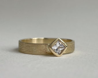Modern East west princess cut engagement ring. Bezel set gold engagement ring. Ethically made. 10kt and 14kt yellow solid gold.