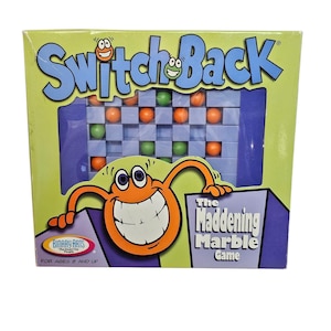 May include: A box for the Switch Back game, The Maddening Marble Game. The box is green, orange, and blue with a cartoon character on the front. The game is for ages 8 and up.