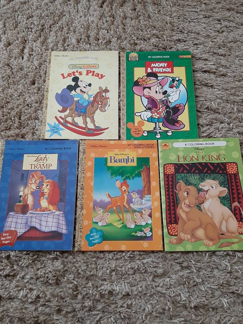 May include: Five Disney coloring books with easy tear-out pages. The books feature Mickey Mouse and friends, Lady and the Tramp, Bambi, and The Lion King. The covers are colorful and feature illustrations of the characters.