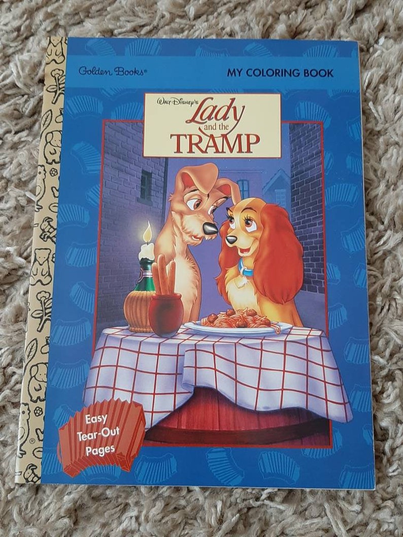 May include: A coloring book featuring Lady and the Tramp from Disney. The cover shows Lady and Tramp sharing a plate of spaghetti. The book has easy tear-out pages. The title of the book is "Lady and the Tramp" and it is a Golden Books publication.