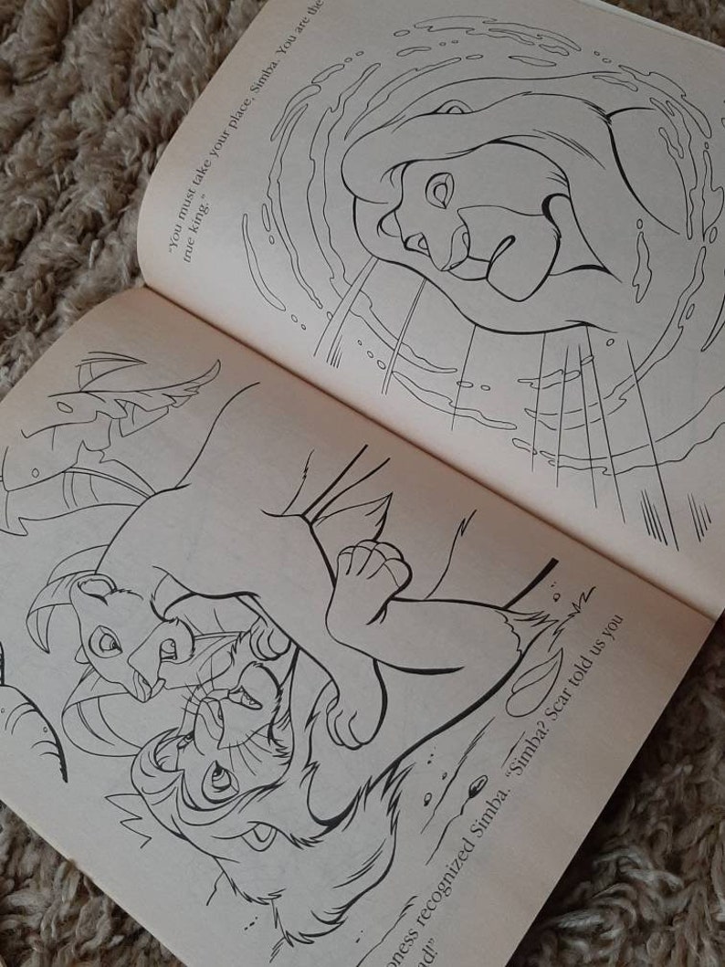 May include: Black and white illustration of a lion cub being held by a larger lion. The text "You must take your place, Simba. You are the true king." is visible in the background.