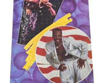 May include: A puzzle featuring two images of MC Hammer. One image shows him shirtless, singing into a microphone. The other image shows him in a white suit. The puzzle has a purple background with bubbles and the name "MC Hammer".