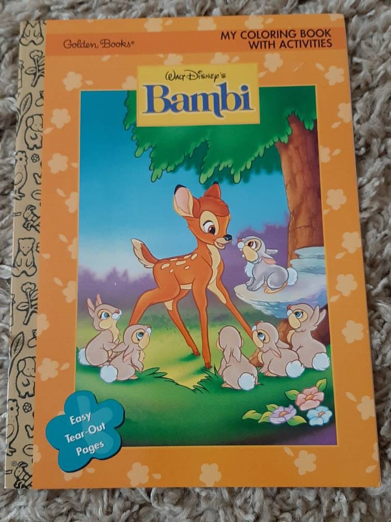 May include: A coloring book featuring Bambi from Disney's Bambi. The cover shows Bambi, a young deer, with Thumper and other rabbits. The book has easy tear-out pages and is designed for children. The book cover is orange with a white border and features the text "My Coloring Book with Activities" and "Walt Disney's Bambi".