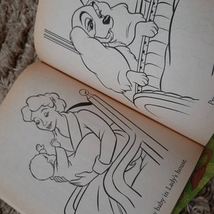 May include: A black and white illustration of a woman holding a baby in a crib. The text "There is a new baby in Lady's house." is written below the image.