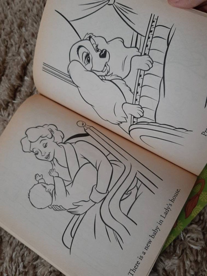 May include: A black and white illustration of a woman holding a baby in a crib. The text "There is a new baby in Lady's house." is written below the image.