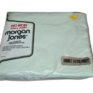 May include: A light blue double fitted sheet made by Morgan Jones. The sheet is made of 65% polyester and 35% cotton and is no-iron. The sheet is for a 54 x 76 inch mattress.