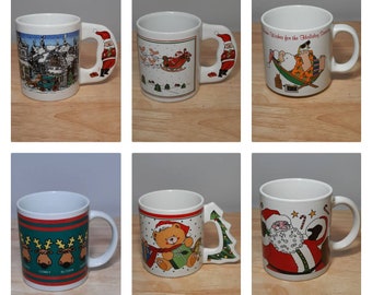 May include: Set of six white ceramic Christmas mugs with various holiday designs. The mugs feature Santa Claus, reindeer, a teddy bear, and a Christmas tree.