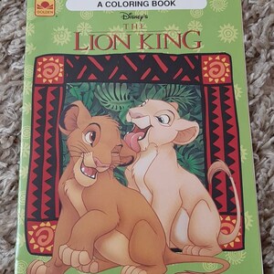 May include: A coloring book featuring Disney's The Lion King. The cover shows Simba and Nala as cubs, with a green background and a red and black patterned border.