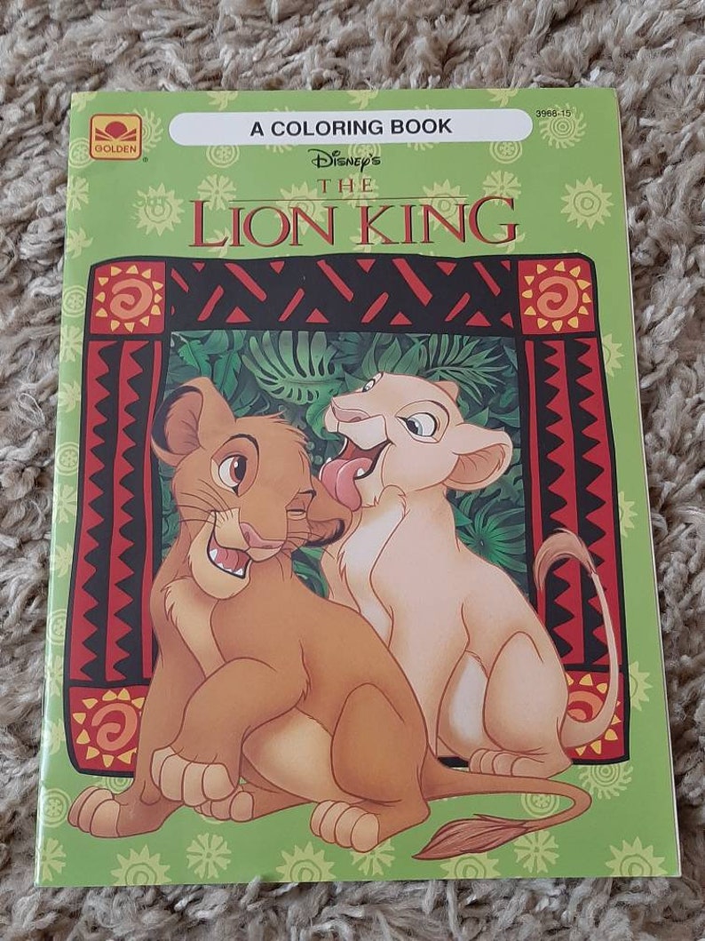 May include: A coloring book featuring Disney's The Lion King. The cover shows Simba and Nala as cubs, with a green background and a red and black patterned border.