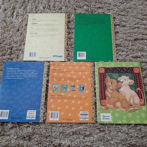 May include: Back covers of five Golden Books featuring The Lion King characters. The books are all different colors and have different designs. The text on the back of the books includes information about the books, such as the author, illustrator, and publisher.