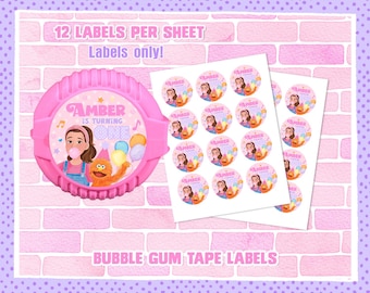 May include: Pink bubble gum tape labels with the text "Amber is turning one." The labels feature a cartoon girl, a monster, and balloons. The image also includes a sheet of round labels with the same design.