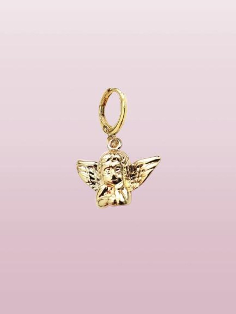 May include: Gold-toned angel charm with wings and a hoop earring attachment.