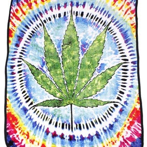 May include: A tie-dye blanket with a green marijuana leaf in the center. The blanket has a circular pattern of colors, including red, orange, yellow, blue, and purple.