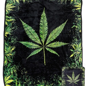 May include: A black and green fleece blanket with a large marijuana leaf design. The back of the blanket has a smaller marijuana leaf design and the word "BACK" printed on it.