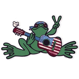 May include: A green frog wearing a red, white, and blue bandana plays a guitar with an American flag design. The frog is holding a peace sign with its right hand.